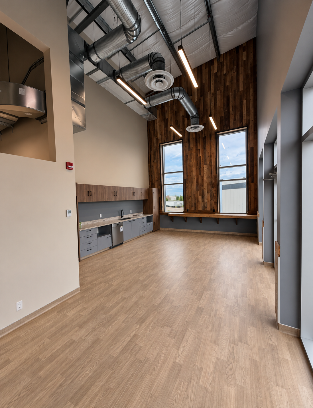Finished commercial interior with feature lighting, exposed ductwork and millwork