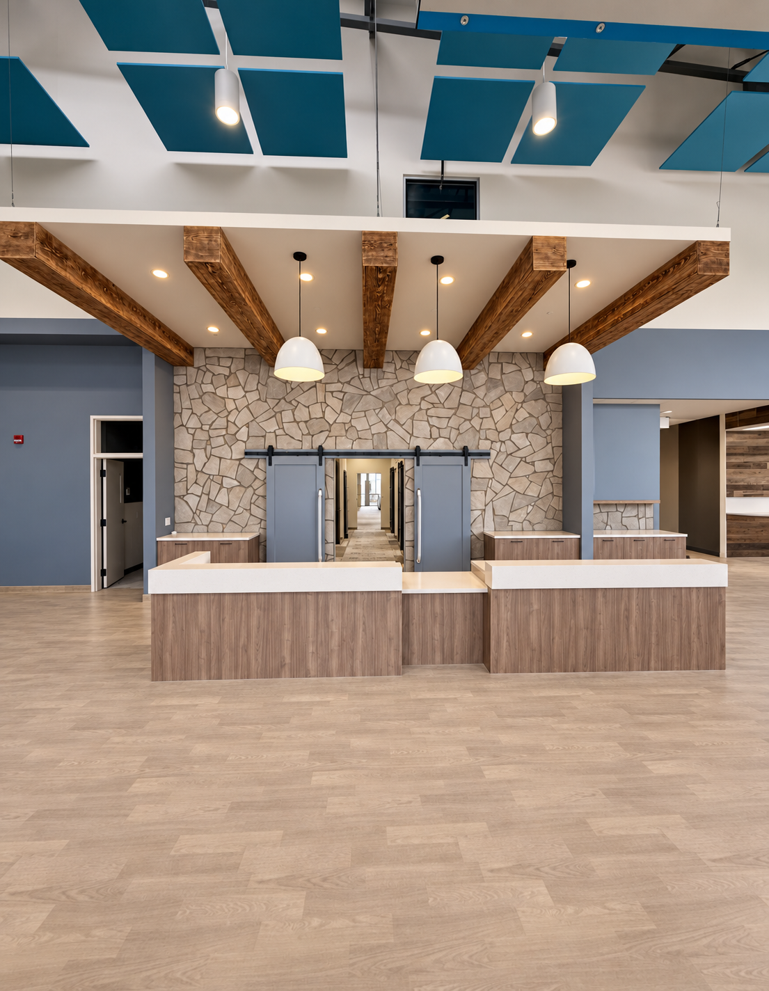 Finished commercial reception area with pendant and architectural lighting