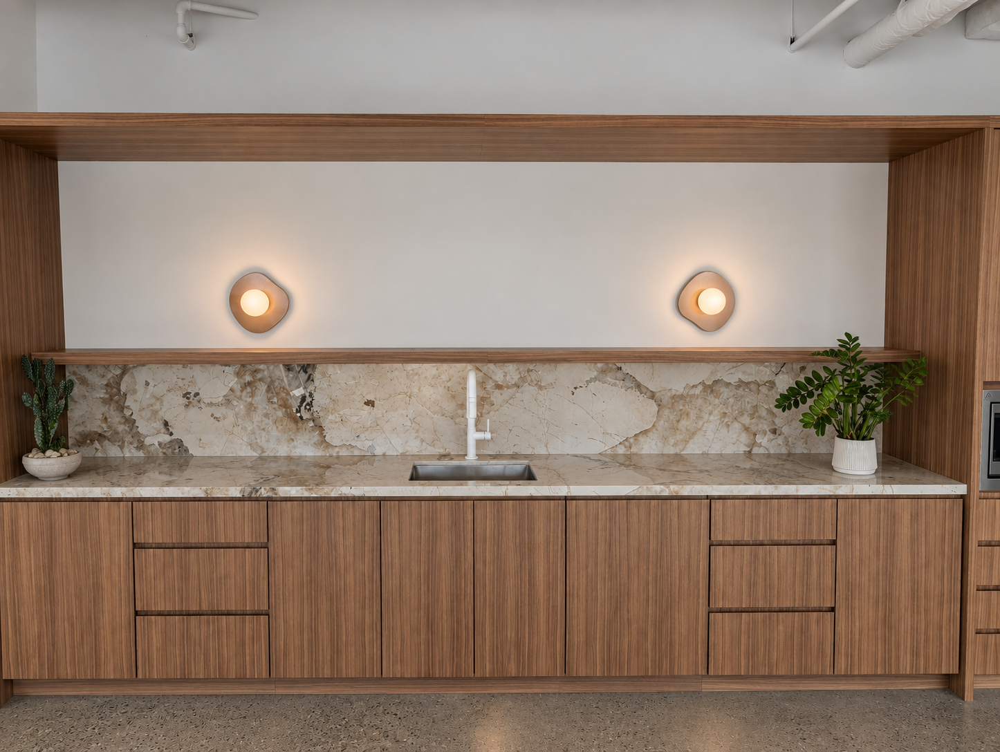 Finished commercial millwork with illuminated sculptural wall sconces
